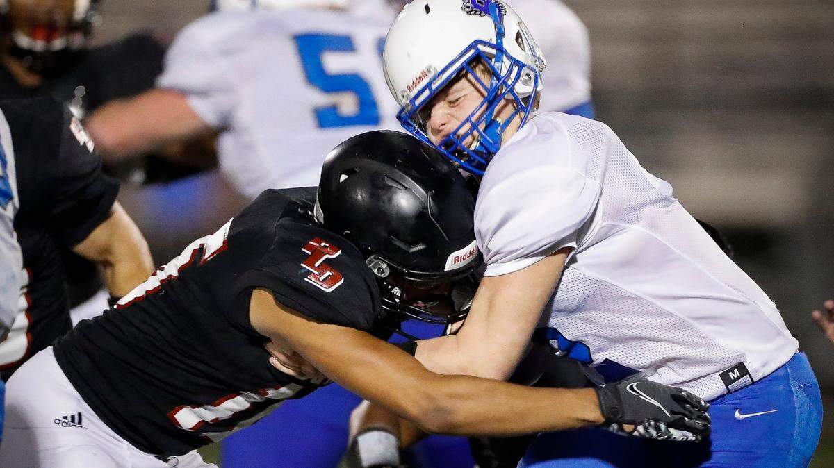 Paul Laurence Dunbar’s Peyton Davis (16) tackles Breathitt County’s Jason Tolson (2) during their game at Paul Laurence Dunbar High School in Lexington, Ky., Friday, Aug. 20, 2021. Paul Laurence Dunbar beat Breathitt County 69-28.