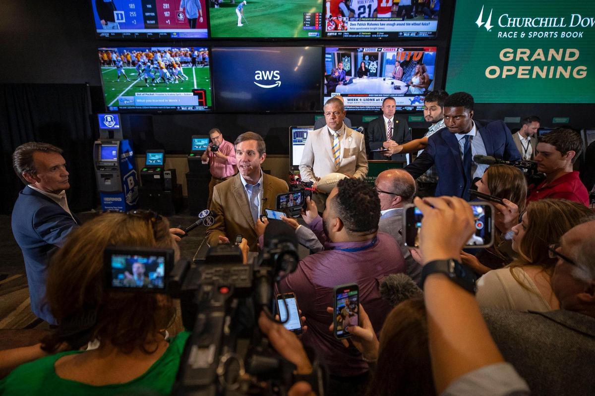 Kentucky Gov. Andy Beshear speaks to members of the media after placing the first sports wager at Aristides Lounge at Churchill Downs on Thursday. Sports betting in Kentucky is projected to bring in about $23 million in annual tax revenue.