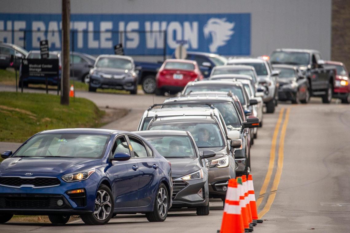 People wait in line for a COVID-19 test at Wild Health’s testing site at 1505 College Way on the University of Kentucky campus in Lexington, Ky., on Monday, Dec. 27, 2021.