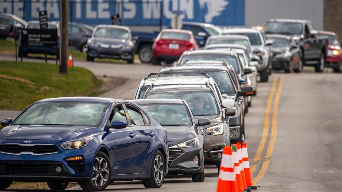 People wait in line for a COVID-19 test at Wild Health’s testing site at 1505 College Way on the University of Kentucky campus in Lexington, Ky., on Monday, Dec. 27, 2021.