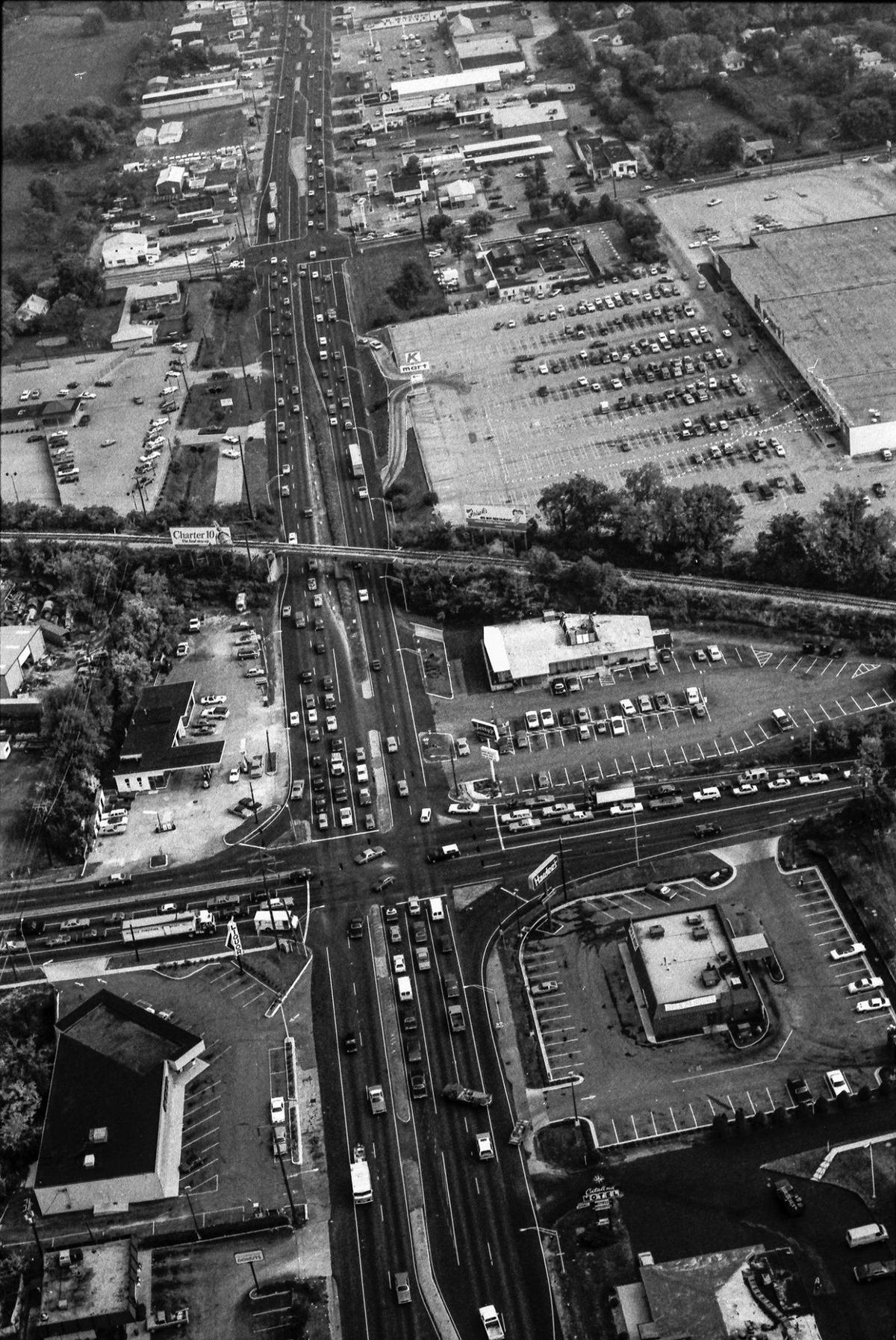The intersection of Lexington’s Broadway, running from left to right across the photo, and New Circle Road, moving straight up the middle of the image, Oct. 4, 1982. At the bottom right corner is the Catalina Motel and restaurant, which opened in 1964. Above that at the intersection of the two roads is a Hardee’s fast-food restaurant and across Broadway is Jerry’s restaurant. The restaurant, which opened in September 1954, was one of the first landmarks people saw when visiting Lexington. It closed in October 1992 and was converted into a Denny’s. Above the Jerry’s just above the railroad tracks is the parking lot for and Lexington’s first, and the 87th in the nation, Kmart. In the bottom left of the image is Shopper’s Village Liquors.