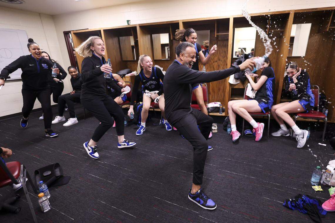 Head coach Kenny Brooks and his staff join in the celebration of Georgia Amoore’s 43-point game and Kentucky’s win over No. 13 Oklahoma in the postgame locker room.