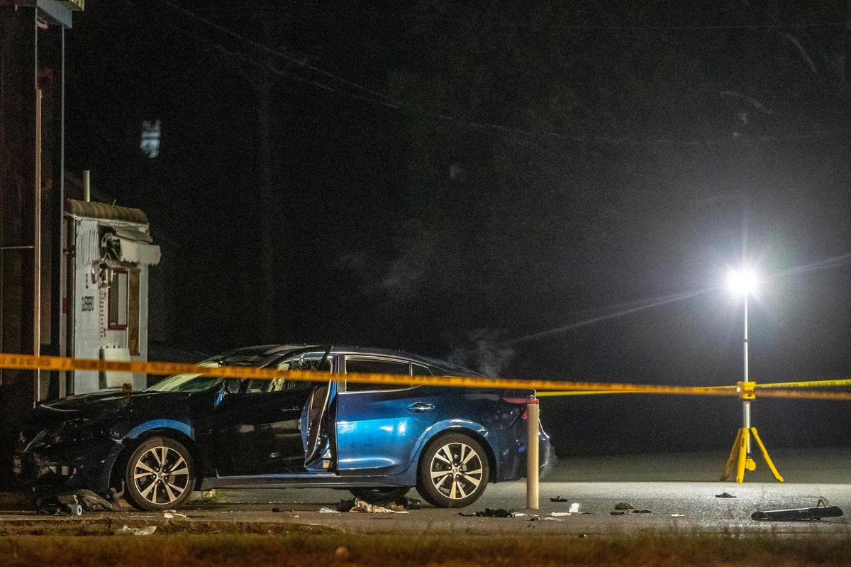 Members of law enforcement investigate the scene where a Lexington police officer and another person were reportedly shot near Deja Vu on New Circle Road.