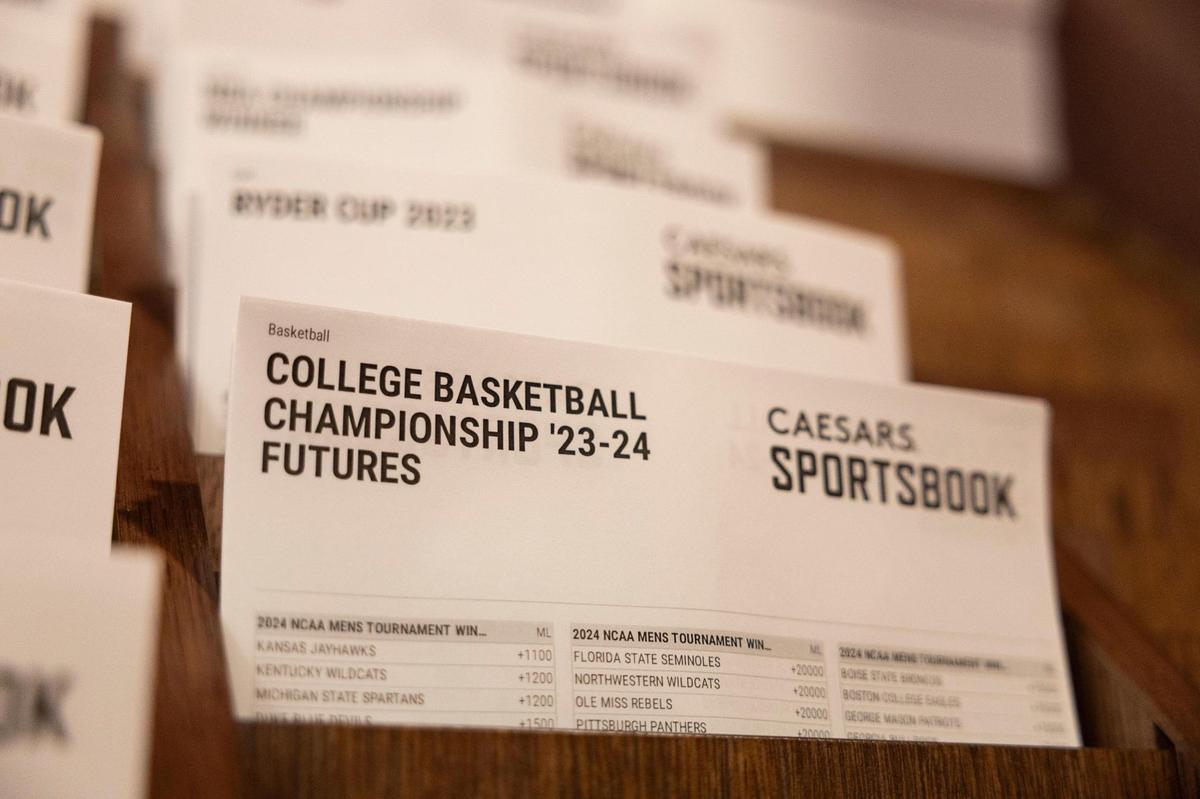 Sports betting guides from Caesars Sportsbook are on display for patrons on the first day of legalized sports betting in Kentucky at Red Mile on Sept. 7.