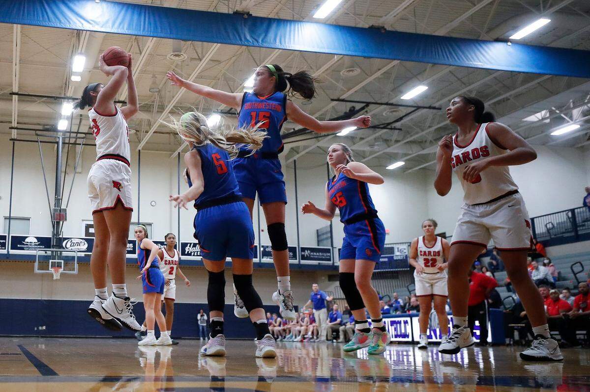 Clark County’s Brianna Byars (23) shoots over Southwestern’s Kaylee Young (5) and Makayla Noritis (15) during the White, Greer & Maggard Orthodontics Holiday Classic at Lexington Catholic on Dec. 21, 2021. Clark County won 62-61.