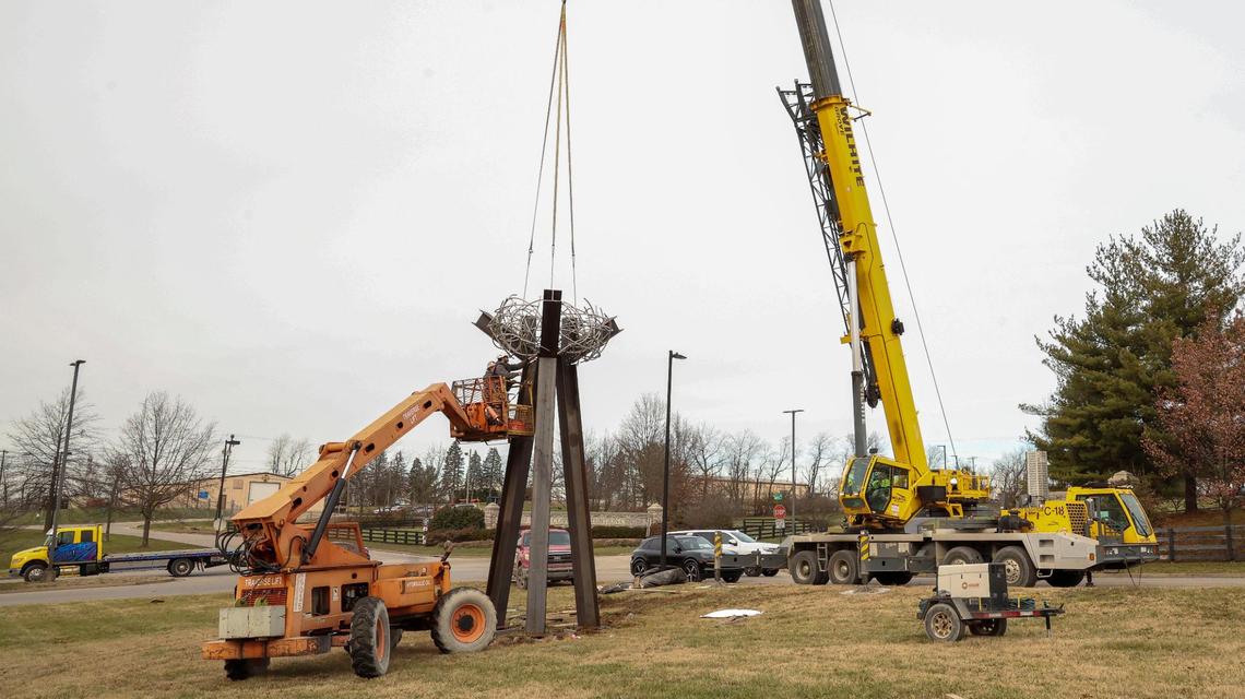 Installers work on placing a new sculpture, “The Birth of Hope,” on the front lawn of the Fayette County Detention Center, Friday, Dec. 13, 2024 in Lexington, Ky. The sculpture, created by Louisville artist Dave Caudill, is a tribute to the spirit of the public servants who work at the facility, Lexington Mayor Linda Gorton said. The sculpture is located in the Old Frankfort Pike corridor, which serves the detention center, local businesses and tourists who travel down Old Frankfort Pike, a National Scenic Byway.