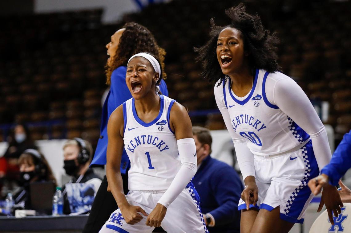Kentucky’s Robyn Benton (1) and Olivia Owens (00) celebrate from the bench after teammate Rhyne Howard scored a basket and was fouled Thursday night. The Wildcats improved to 8-3 overall in winning their SEC opener.