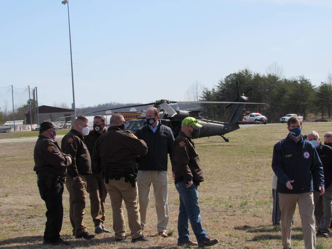Gov. Andy Beshear, right in blue jacket, arrived in Beatyville on March 5, 2021 after flying over flood damage in several counties.