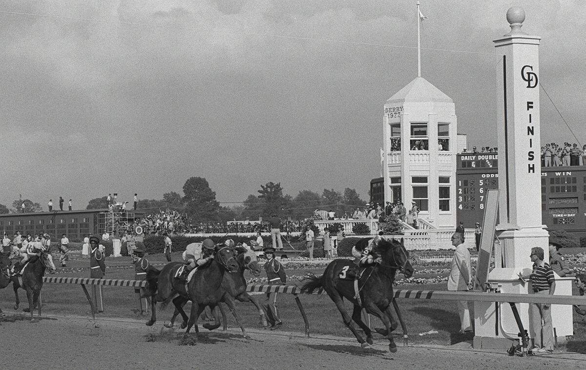 Seattle Slew and jockey Jean Cruguet hit the finish line ahead of Run Dusty Run, on the outside and third-place finisher Sanhedrin, on the inside, in the 103rd Kentucky Derby in 1977. Seattle Slew went on to win the Preakness and the Belmont to become the 10th Triple Crown winner of all time.