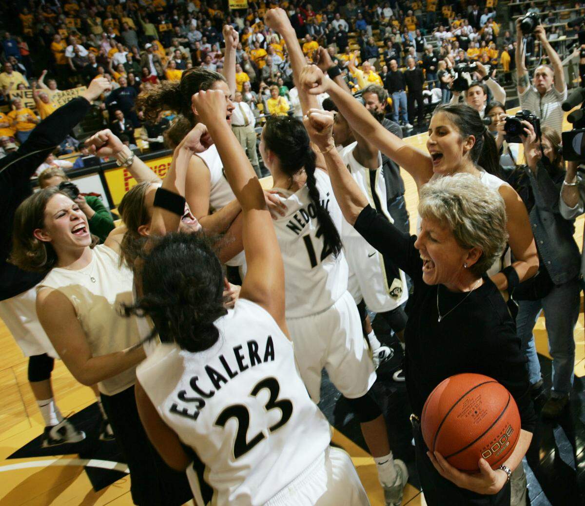 Colorado women's basketball coach Ceal Barry, lower right, celebrated with her players after a victory over Nebraska in Boulder, Colo., on March 2, 2005. Barry retired at the end of that season.