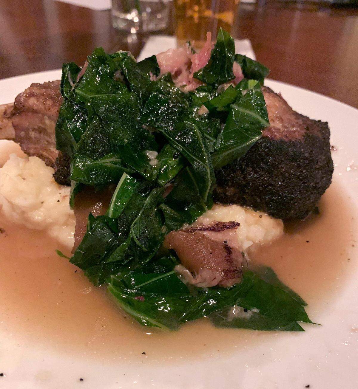 Honeysuckle’s coffee-crusted Berkshire pork chop comes with collard greens and goat cheese mashed potatoes. The new restaurant opened in Berea in the former Churchill Weavers loom house on Jan. 26.