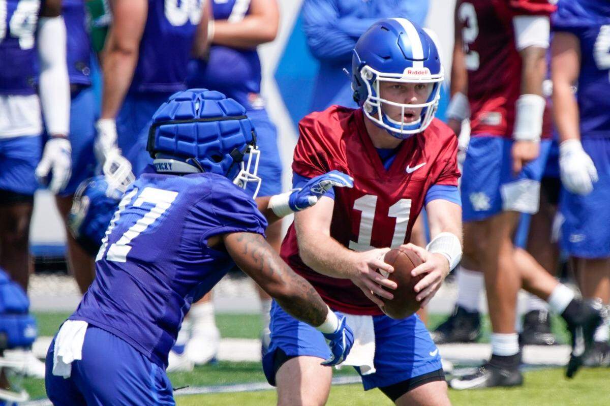 Beau Allen (11), Kentuck’s No. 2 quarterback, handed off to JuTahn McClain during a practice on Aug. 7.