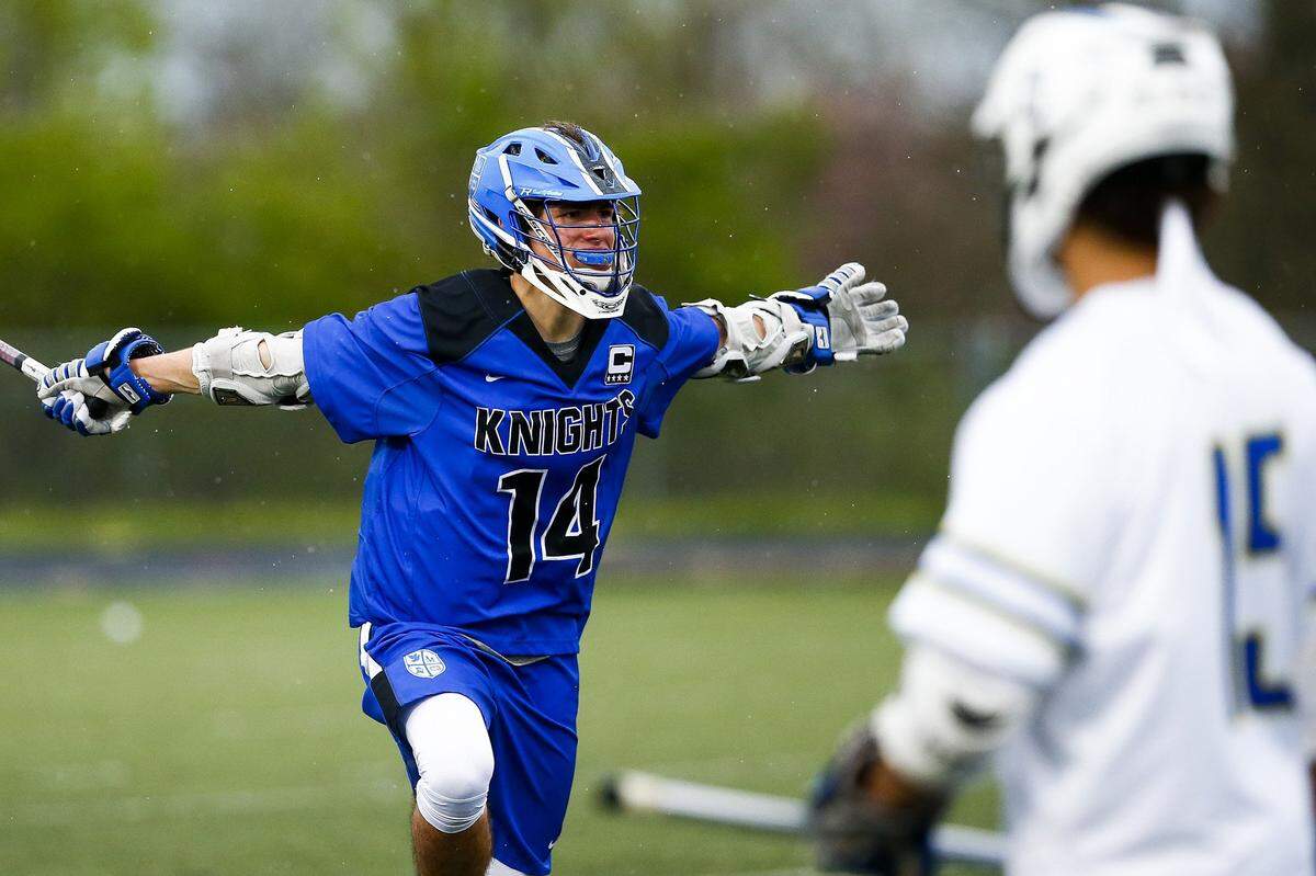 Lexington Catholic's Joseph Stuber (14) celebrated a goal past Henry Clay's Isaiah Adkins (15) during their game Saturday, April 14, at Henry Clay High School.