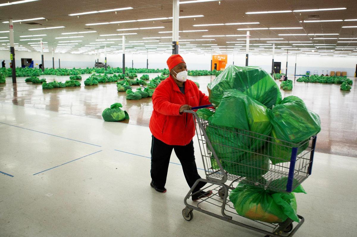 Tracy Cason, a Salvation Army staff member, gathered bags of gifts for pickup during the Salvation Army Angel Tree gift pick up on Dec. 18 in Lexington.