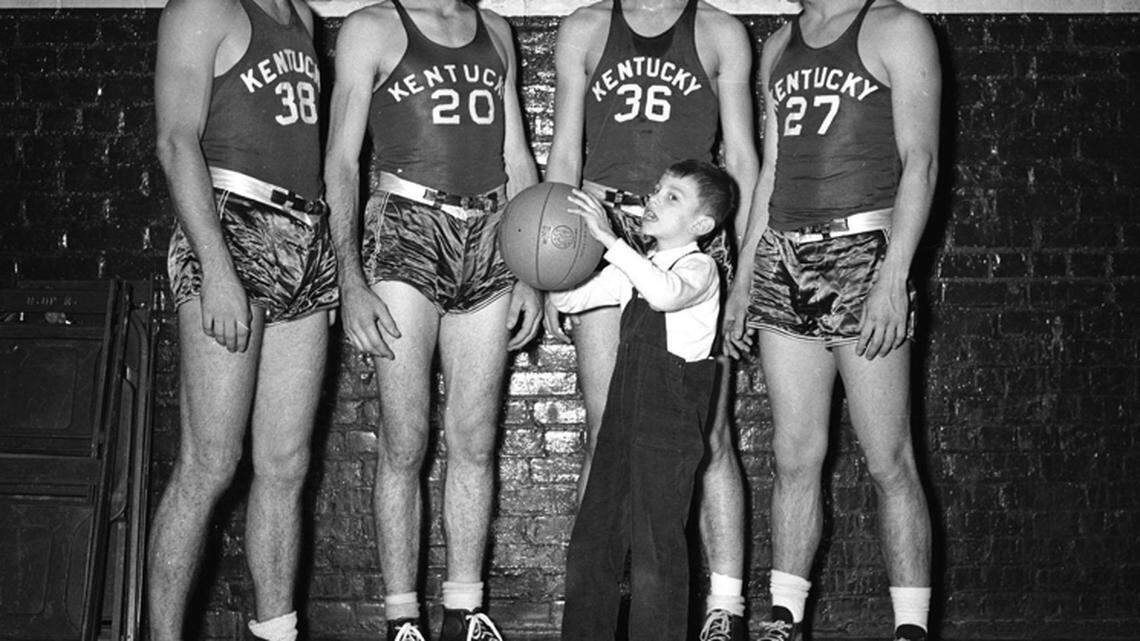 University of Kentucky basketball players,  from left, Dutch Campbell, Bob Brannum, Alex Groza and Wallace Jones,  photographed with Adolph Rupp's son Herky in December of 1946.