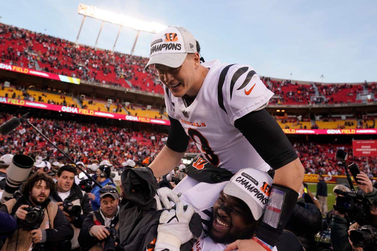 Cincinnati Bengals quarterback Joe Burrow (9) celebrates with teammate Tyler Shelvin at the end of the AFC Championship Game against the Kansas City Chiefs on Jan. 30. The Bengals won 27-24 in overtime.