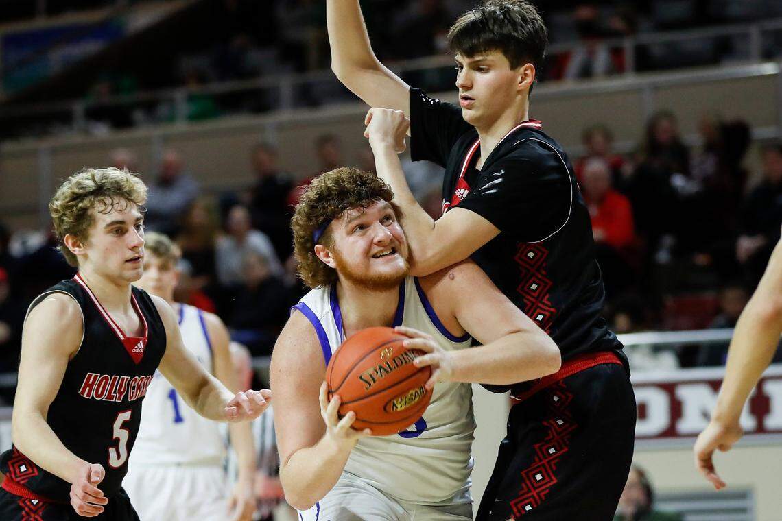 Breathitt County power forward Bryce Hoskins, center, is a tight end and linebacker for the Bobcats in football.