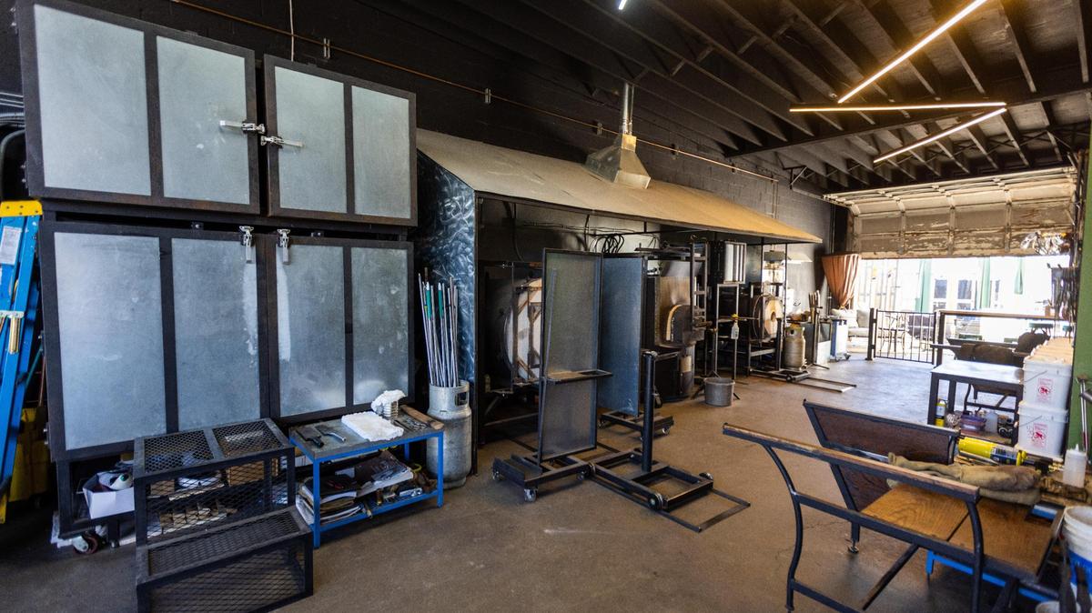 The glass blowing studio space at Trifecta Glass Art Lounge has live glass blowing demonstrations by artists like owner Travis Adams and classes for those who want to learn the art.