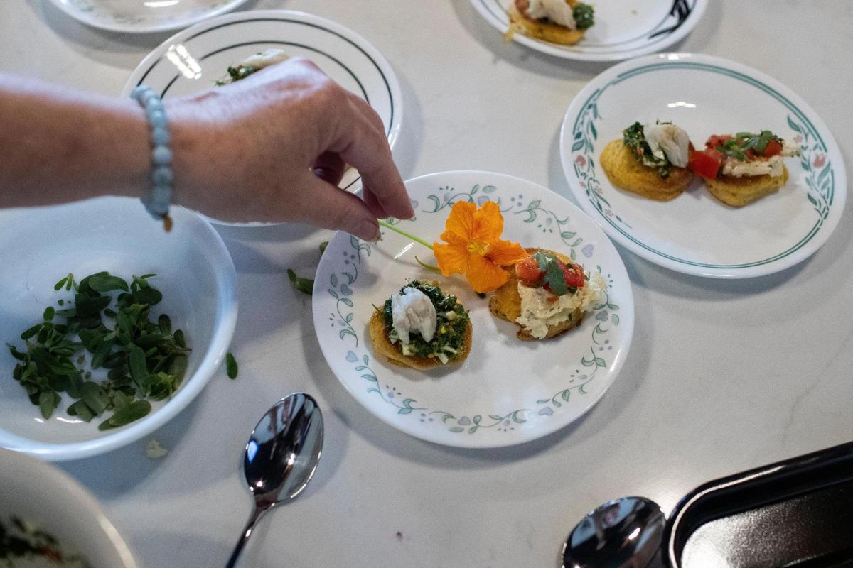 Chef Ouita Michel prepared tiny hoecakes with a nasturtium salsa verde and lump crab cake.