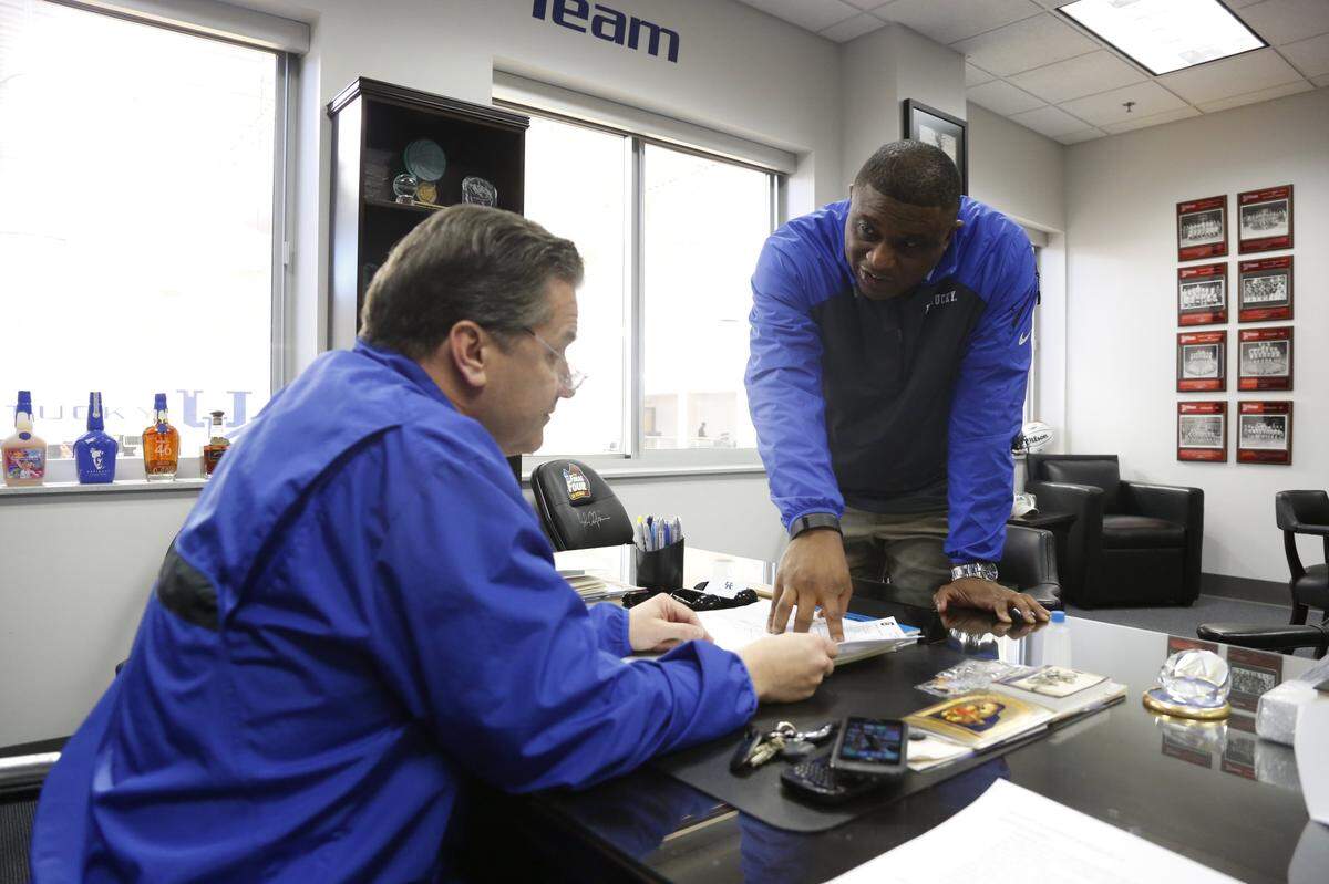 DeWayne Peevy, right, worked closely with basketball coach John Calipari, left, during his time at UK. Among Peevy’s duties was helping develop the Wildcats’ schedule.