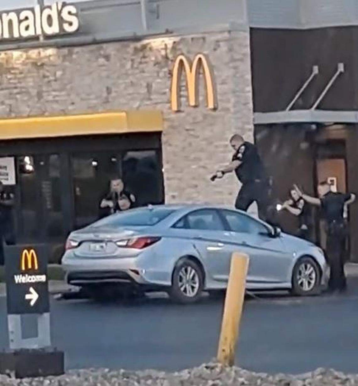 Bystander video shows a Georgetown police officer standing on the hood of a car after multiple officers opened fire on a suspect in an attempted car theft.