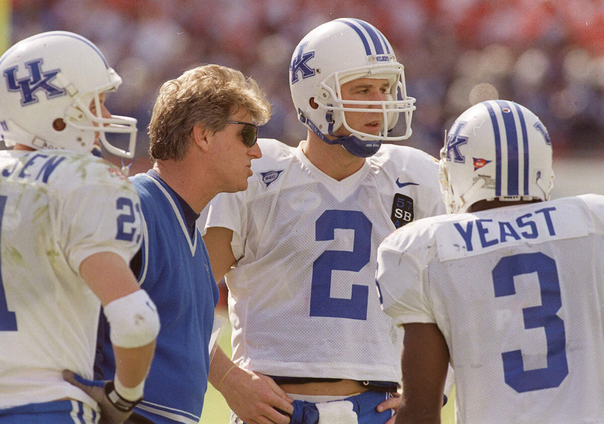 Kentucky head coach Hal Mumme talked with quarter back Tim Couch (2) and wide receivers Lance Mickelsen (21) and Craig Yeast (3) during the Outback Bowl against Penn State in Tampa, Fla., on Jan. 1, 1999.