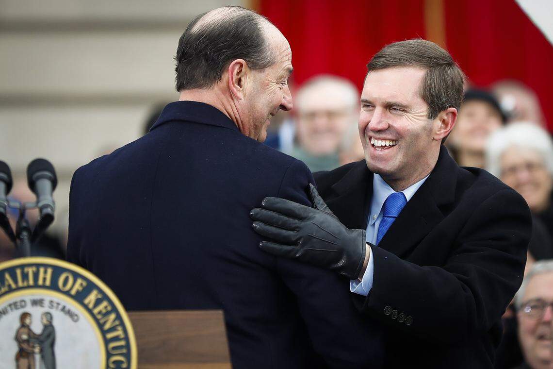 Kentucky Gov. Andy Beshear laughs with senior advisor Rocky Adkins during his during his public inauguration ceremony at the state Capitol in Frankfort, Ky., Tuesday, Dec. 10, 2019.