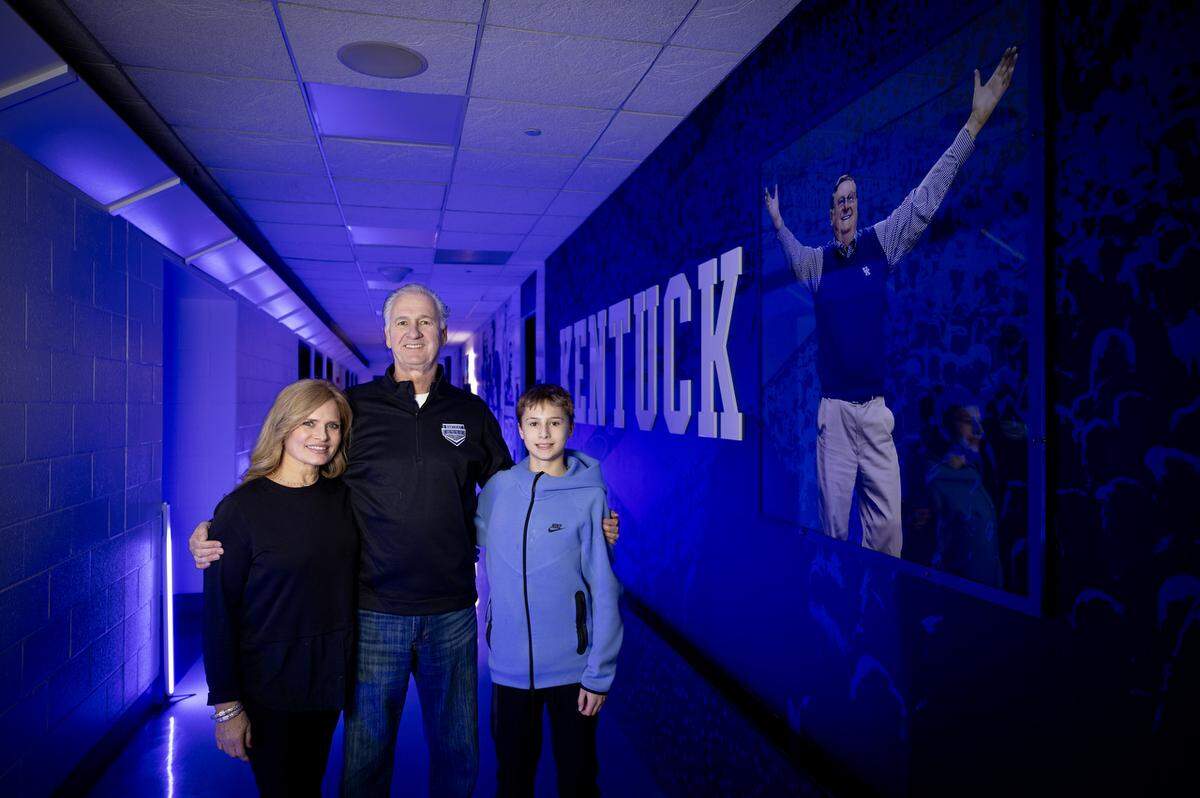 Jim Master, center, his wife, Sheila, and their son, Leo, were at Rupp Arena last weekend to take part in a reunion for Kentucky’s 1984 Final Four team.