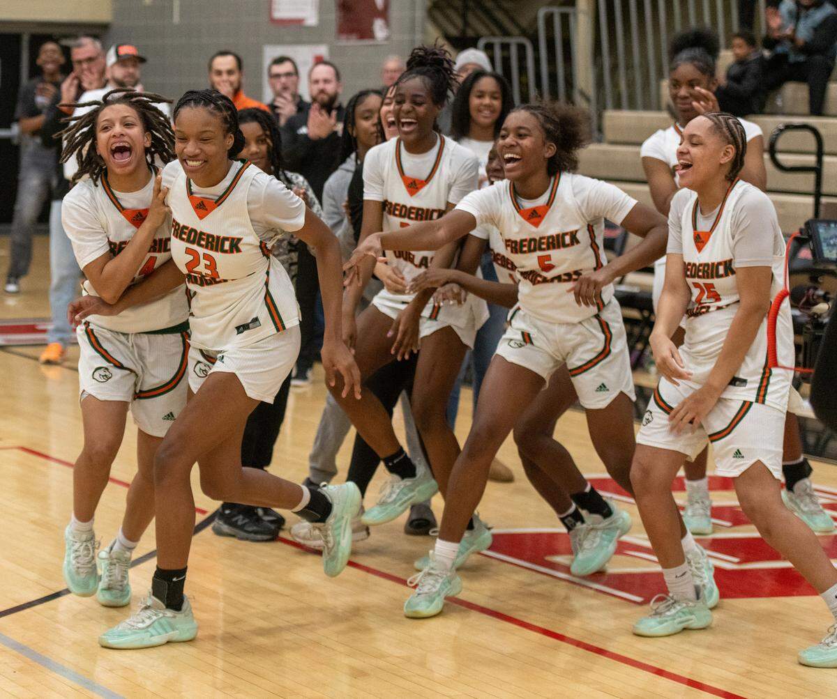 Jaelee Knowles (23) is cheered on by her teammates as she accepts the 11th Region Tournament MVP award. Knowles had 19 points and 11 rebounds in the Broncos’ 68-41 win over Madison Central.