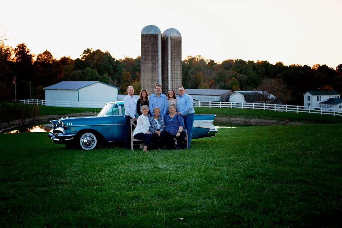 The Jones family gathered around matriarch Inis Jones earlier this year for a photo that also shows their farm in the background, including barns and grain silos. Many of the buildings were damaged or destroyed by a tornado.
