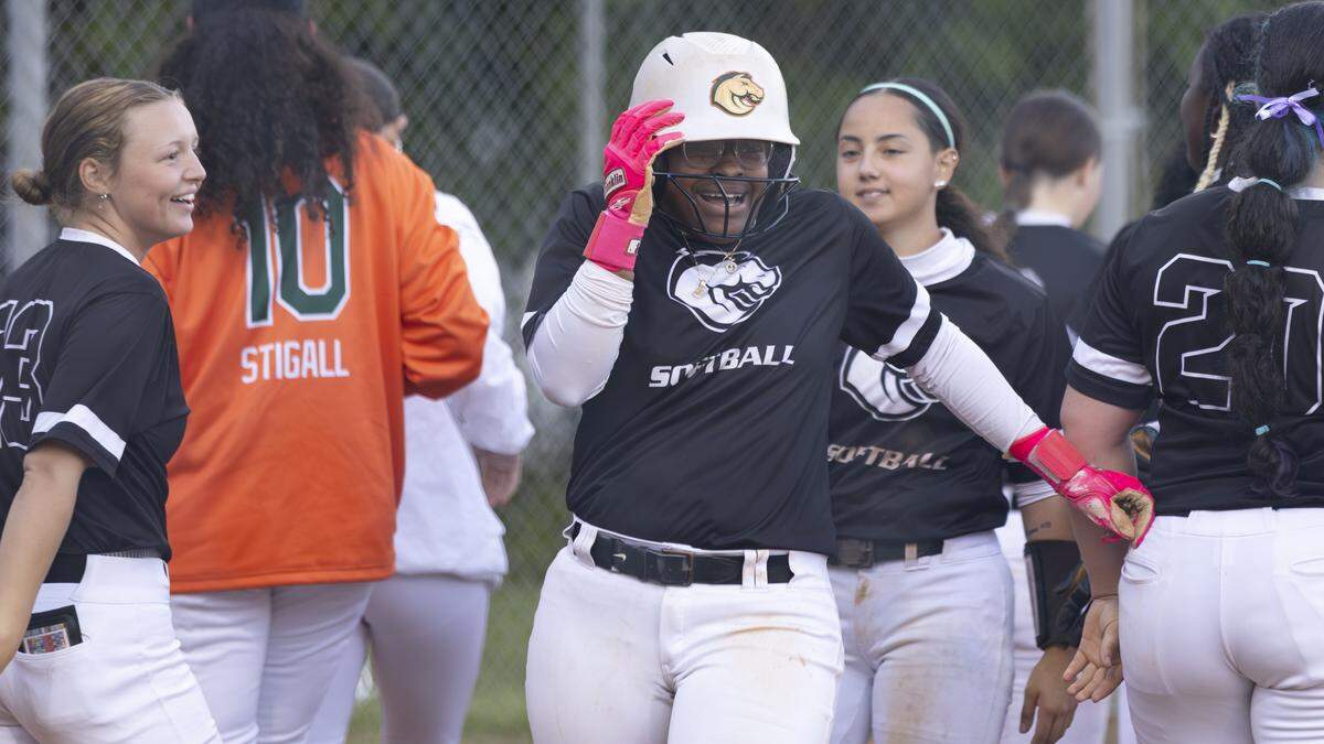 Frederick Douglass shortstop Jarynn Bowman, laughs after her escape from her teammates’ helmet-slapping home run celebration for her at the plate during the Broncos’ 11-4 victory at Bryan Station on Thursday.