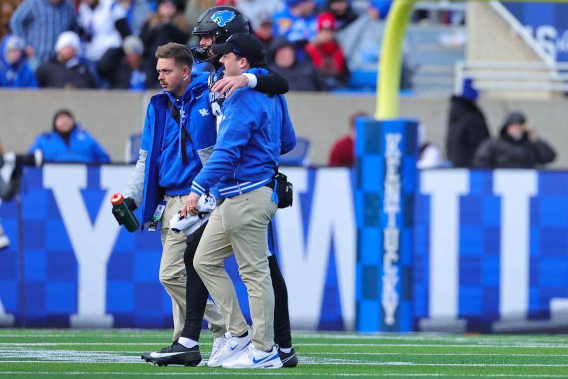 Kentucky quarterback Cutter Boley, center, leaves the field after being injured against Louisville on Saturday at Kroger Field.