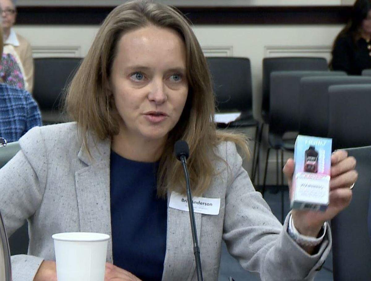 Dr. Brit Anderson held a box of sour raspberry bubblegum flavored vape juice at a state legislative hearing.