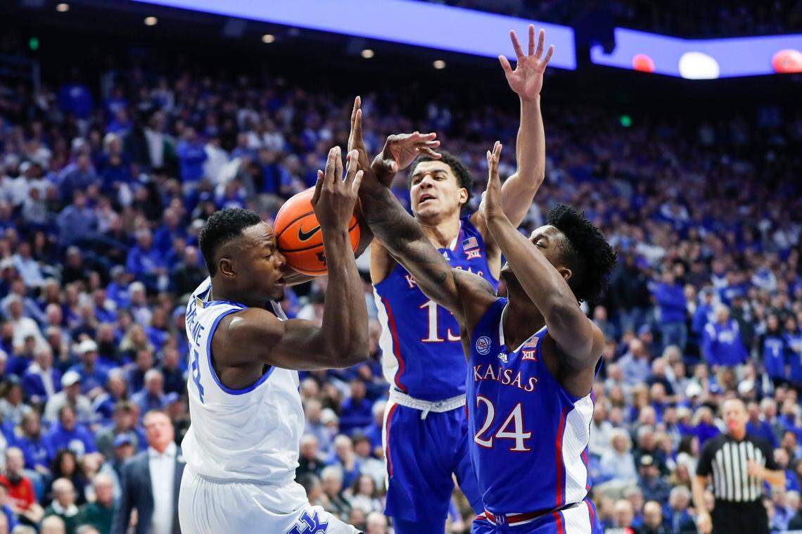 Kentucky’s Oscar Tshiebwe, left, fights for a rebound with Kansas’ K.J. Adams Jr. (24) during Saturday’s game at Rupp Arena.