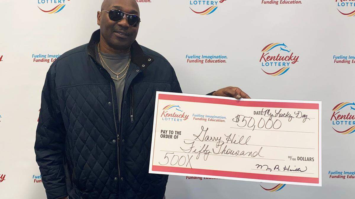 Garry Hill of Lexington poses with his big check from Kentucky Lottery in Louisville after winning $50,000 on a scratch-off this week.