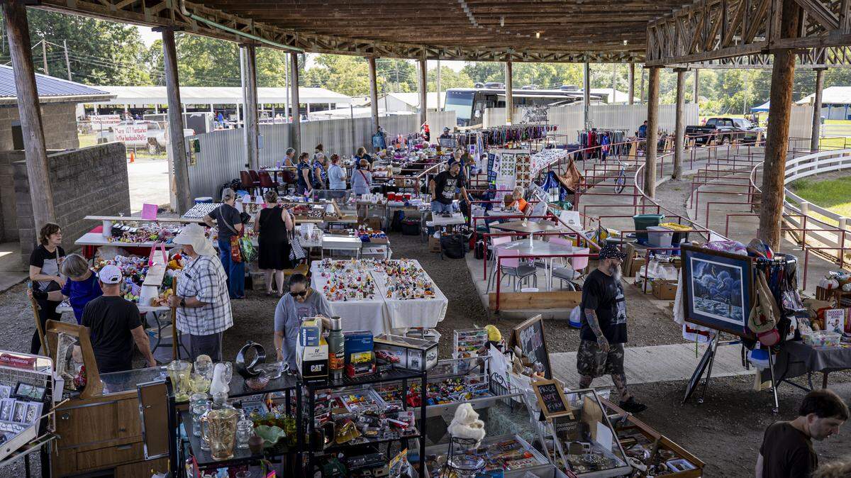 People walk through booths during the annual 127 Yard Sale on Friday, Aug. 8, 2025, in Lawrenceburg, Ky.