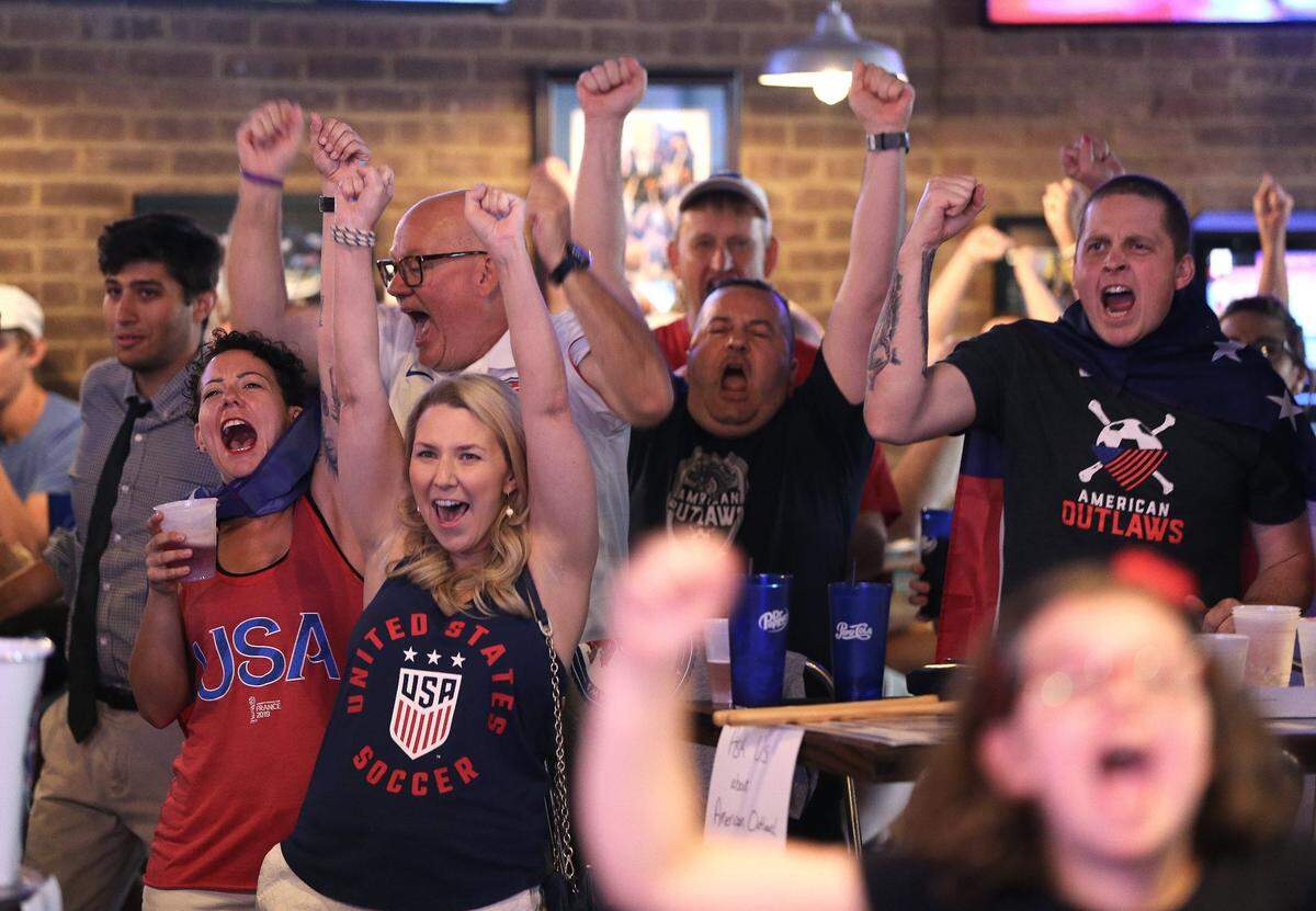 Nikki Gilland, left, Rachel Mathis and Kevin Collins reacted after Megan Rapinoe scored for the US WomenÍs National Team Sunday during a watch party for the FIFA WomenÍs World Cup final at KSR Bar and Grill.