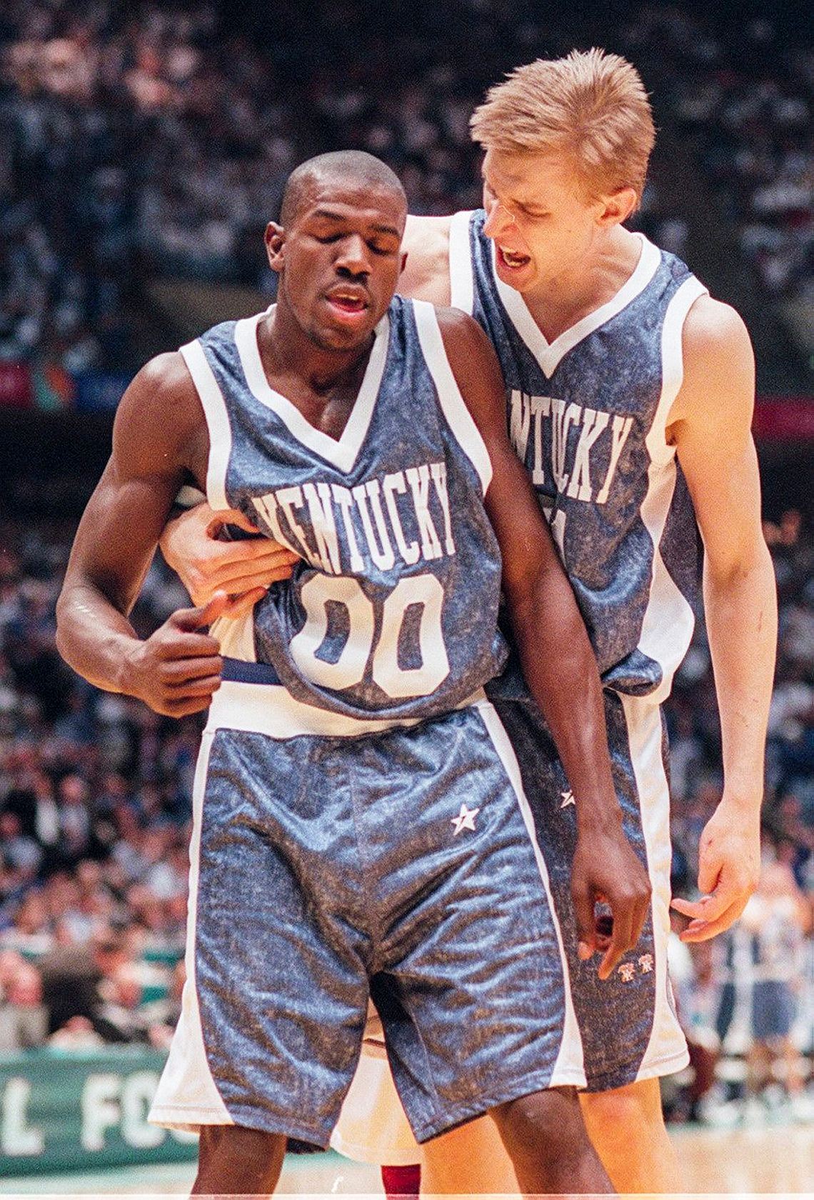 UK’s Mark Pope hugs Tony Delk after Delk was fouled while making a basket during the second half of the National semi-final game against a John Calipari coached UMass team in East Rutherford, N.J., March 30, 1996. UK won 81-74 and would go on to beat Syracuse in the NCAA title game two days later for the school’s sixth national championship.
