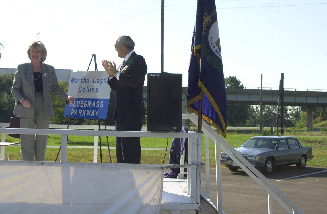 Former Gov. Martha Layne  Collins, left, smiles as Gov. Paul Patton applauds the unveiling of a Matha Layne Collins Bluegrass Parkway sign during the parkway's renaming ceremonies Thursday, Sept. 18, 2003, outside the Woodford Community  Christian Church in Woodford County.