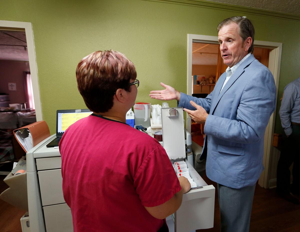 Signature Healthcare CEO and President Joe Steier, right, talked to LPN Trish Lister as he took a tour Wednesday morning at Harrodsburg Health & Rehabilitation Center, 853 Lexington Road in Harrodsburg, Ky. The nursing home is owned by Signature HealthCare of Louisville.
