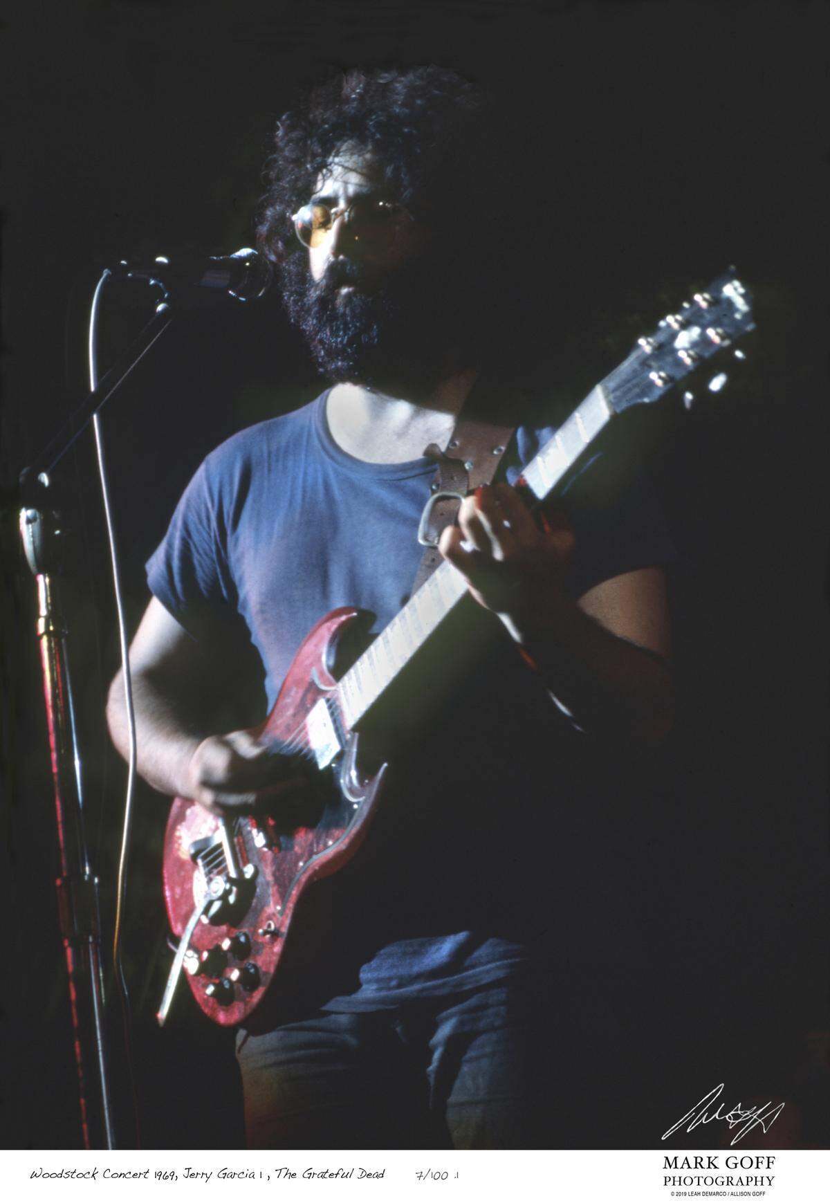 This August, 1969 photo shows Jerry Garcia as he performs during Woodstock in Bethel, N.Y. The photo is only one of hundreds made by photographer Mark Goff who, at the time, worked for an underground newspaper in Milwaukee, Wis. Some were published, but the negatives were filed away at his Milwaukee home and barely mentioned as Goff raised two daughters, changed careers and, last November, died of cancer. Dozens of Goff’s Woodstock shots are being displayed 50 years later. (Mark Goff Photography, Leah Demarco/Allison Goff via AP)