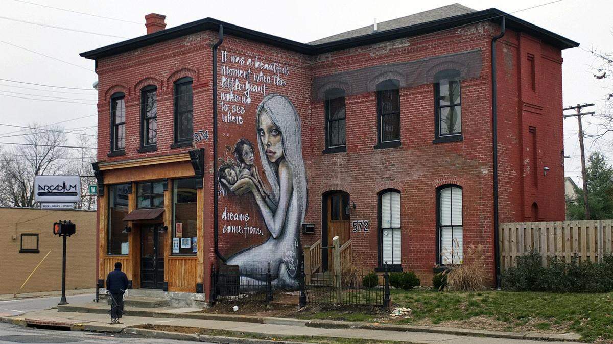 The first of five old Lexington buildings Chad Needham restored was the old Spalding's Bakery at the corner of North Limestone and East Sixth Street in 2009. Needham now leases it to the Arcadium bar. German artists Jasmin Siddiqui and Falk Lehman, who call their team Herakut, painted the mural last fall. Needham is now working on his sixth and seventh buildings, two 1800s houses on Constitution Street. Photo by Tom Eblen | teblen@herald-leader.com
