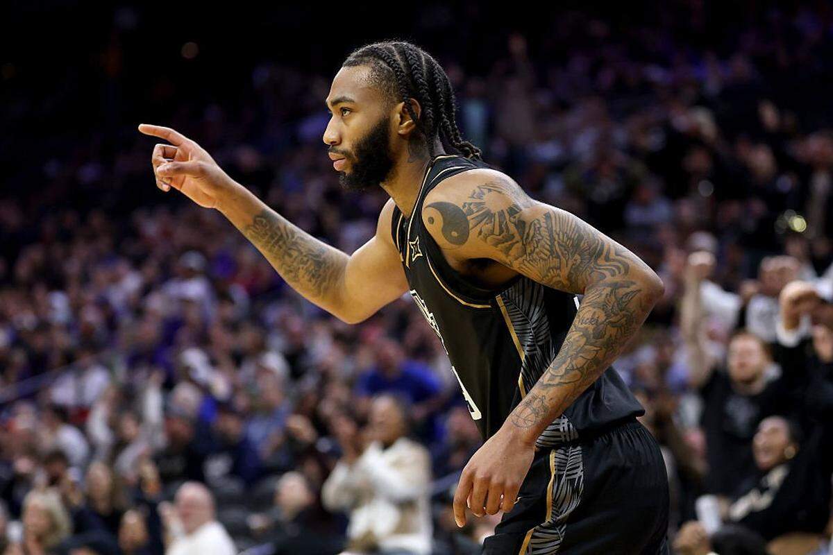 PHILADELPHIA, PENNSYLVANIA - MARCH 20: Jordan Burks #99 of the UCF Knights celebrates his three-point basket against the UCLA Bruins during the second half in the first round of the 2026 NCAA Men's Basketball Tournament at Xfinity Mobile Arena on March 20, 2026 in Philadelphia, Pennsylvania. (Photo by Emilee Chinn/Getty Images)