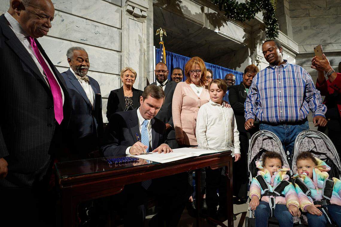 Kentucky Governor Andy Beshear, a Democrat, signs an executive order to reinstate the voting rights of over 100,000 non-violent felons who have completed their sentences, at the Capitol in Frankfort, Ky., Thu, Dec. 12, 2019.