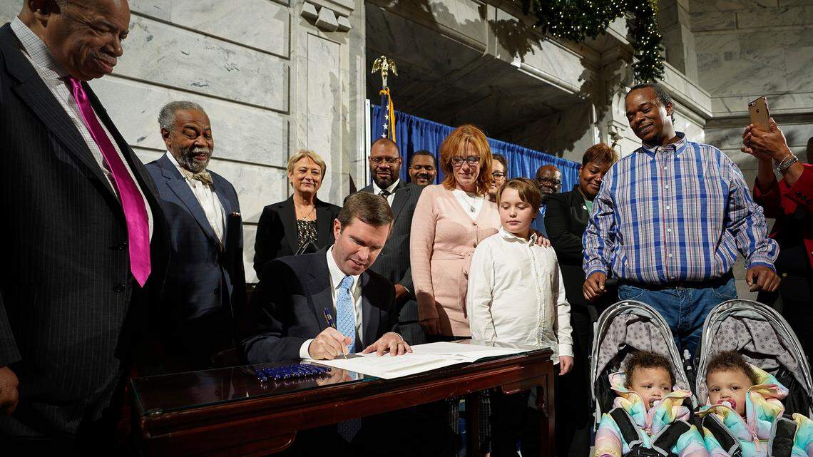 Kentucky Governor Andy Beshear, a Democrat, signs an executive order to reinstate the voting rights of over 100,000 non-violent felons who have completed their sentences, at the Capitol in Frankfort, Ky., Thu, Dec. 12, 2019.