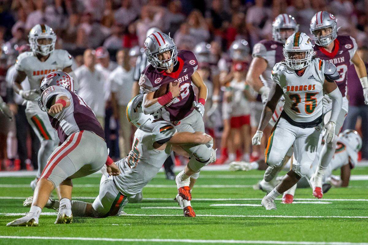 Frederick Douglass’ Logan Busson (16) tackles Corbin’s Cam Estep (12) during Friday’s game at Corbin’s Campbell Field.