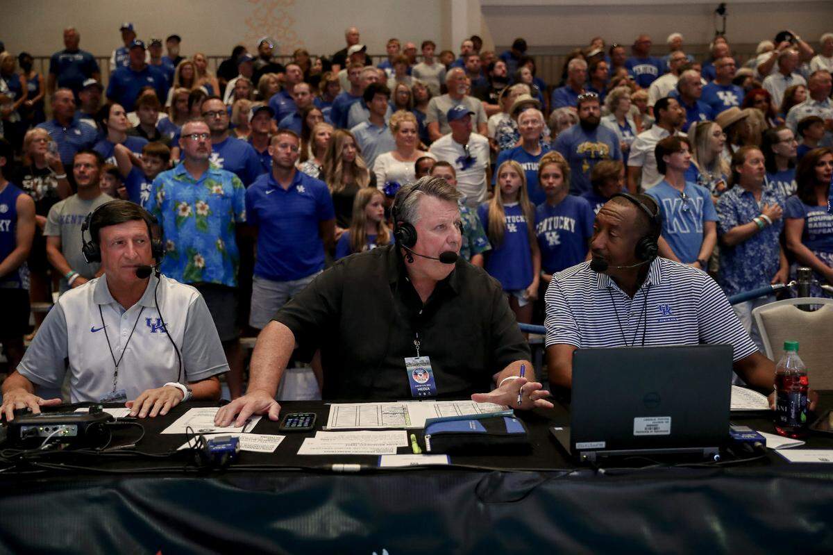 Tom Leach, center, the longtime radio play-by-play voice of Kentucky Wildcats football and men’s basketball, is part of the 2023 (state of) Kentucky Sports Hall of Fame class. “He does a great job of painting it blue in just the right way,” UK Athletics Director Mitch Barnhart said of Leach. “I think that takes a real skill and a real heart.”