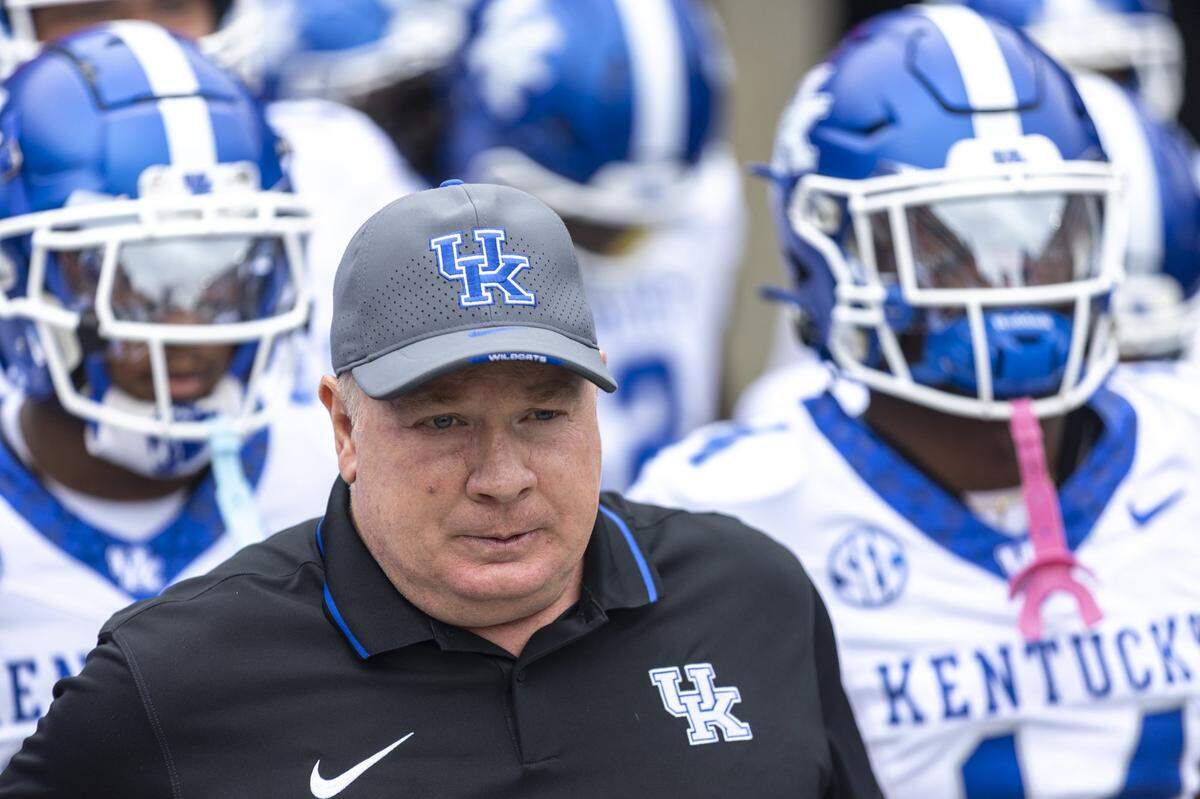 Kentucky head coach Mark Stoops leads his team onto the field before Saturday’s game at Georgia.