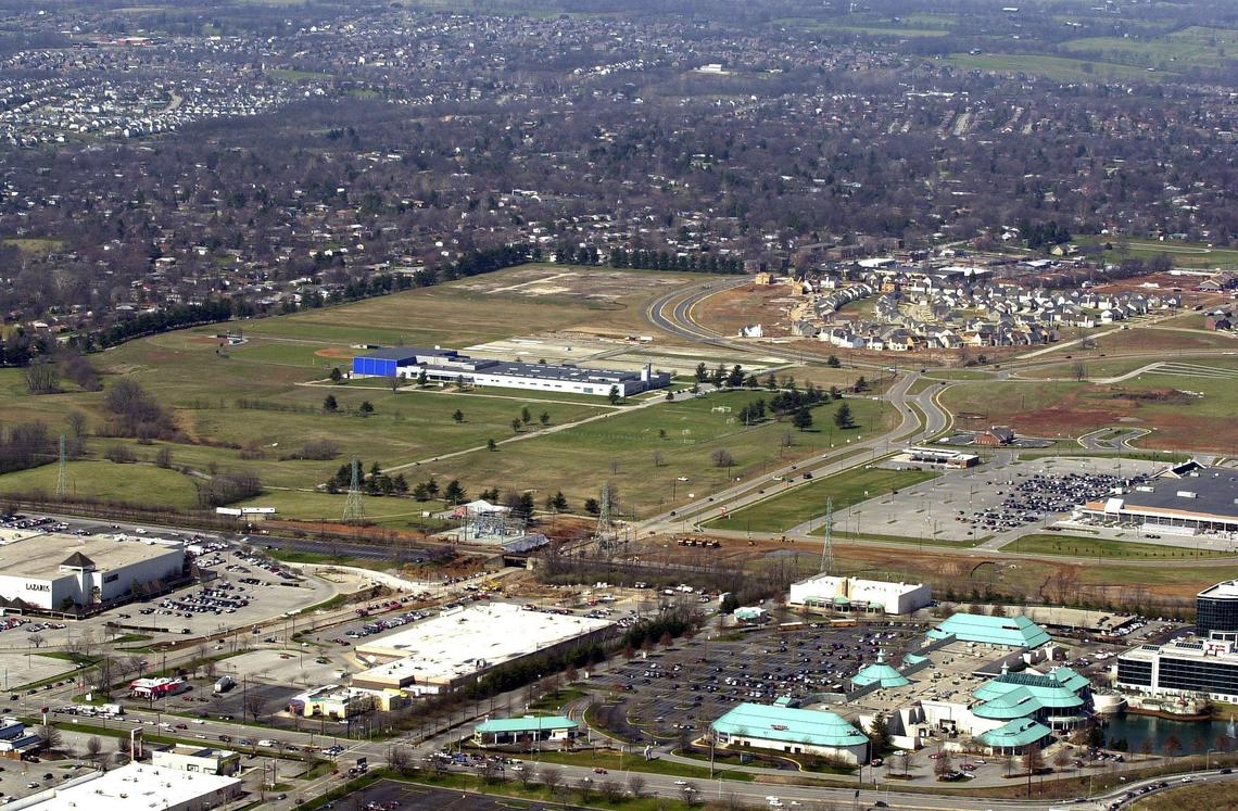 Aerial view, looking towards the west, taken Friday, March 29, 2002 in Lexington. In the lower left at the intersection of Nicholasville and Reynolds Roads is an Arby’s restaurant that has been at that location since 1980. Just above it is part of Fayette Mall, specifically Lazarus department store, and on the other side of Reynolds Road, Target and Lexington Green shopping center. In middle is Lexington Christian Academy and in middle at right is Meijer’s. Above LCA is part of an undeveloped area that would become Wellington Elementary School. The round-a-bout on Reynolds Road and Wellington Way can be seen just before the development of homes.