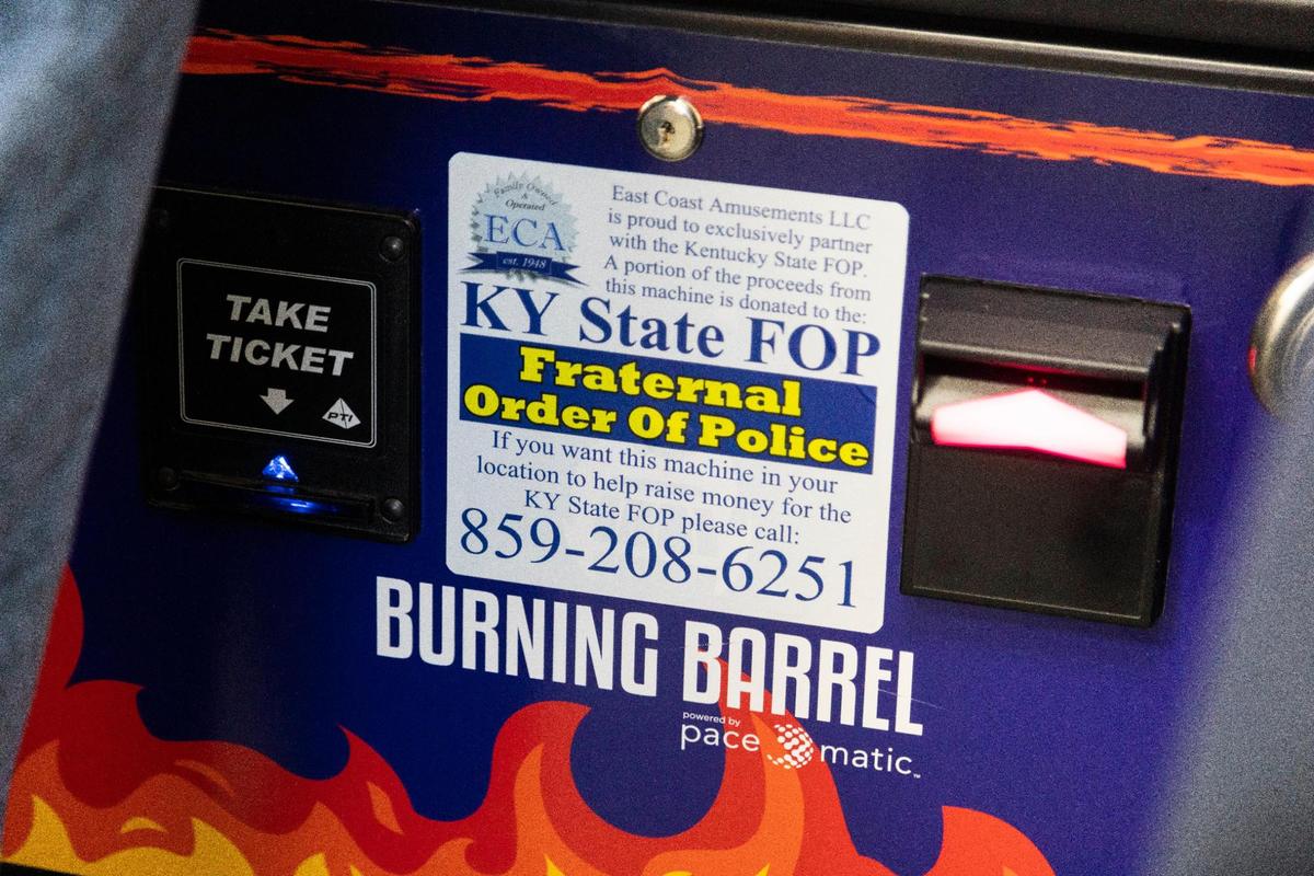 Stickers on some Burning Barrel unregulated gambling machines like this one at Fraternal Order of Police post 59 in Georgetown say that the Kentucky State FOP gets a cut of the money bet. The maker, Pace-o-Matic, and the FOP contend the machines are games of skill and legal.